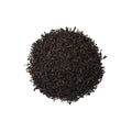 Cup of Lake Missoula Tea Company's Lychee Black tea in a white mug, showing dark brewed tea with lychee flavor hints.