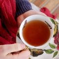 A cup of Sweet Chamomile Black tea from Lake Missoula Tea Company, showcasing a brewed black tea with chamomile flowers.