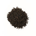Loose leaf Dom Dom Assam tea from Lake Missoula Tea Company, showing dark amber tea leaves in a clear glass jar.