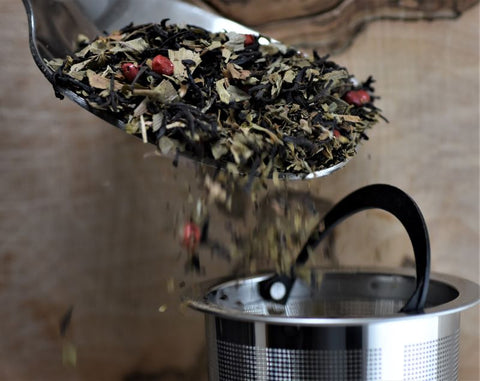 Ginkgo Brain Tea by Lake Missoula Tea Company in a clear glass cup showing golden brewed tea with ginkgo leaf garnish.