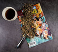 Wonder Woman tea from Lake Missoula Tea Company in a clear glass cup, showcasing vibrant tea leaves and a hero-themed design.