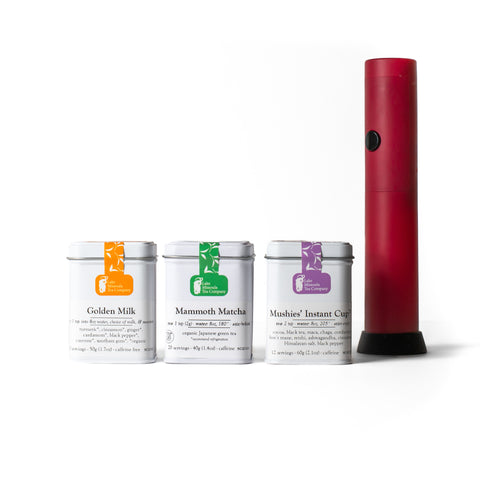Assorted powder tea bundles from Lake Missoula Tea Company displayed in colorful packaging on a wooden surface.