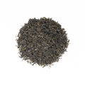 Fresh green Darjeeling District tea leaves from Lake Missoula Tea Company, showcasing vibrant, dried tea leaves in a close-up shot.