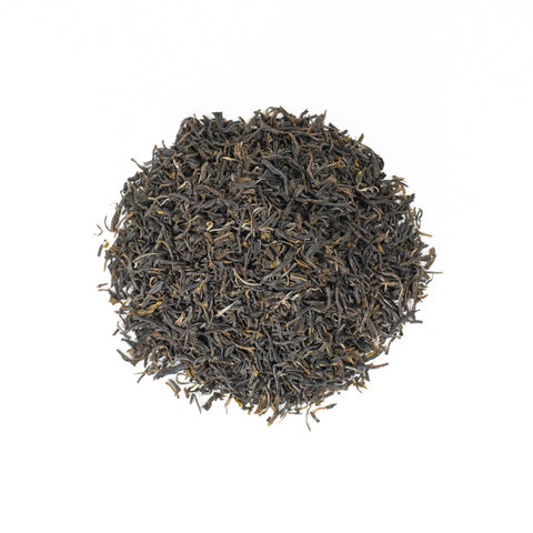 Fresh green Darjeeling District tea leaves from Lake Missoula Tea Company, showcasing vibrant, dried tea leaves in a close-up shot.