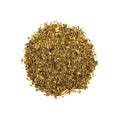 A cup of herbal headache relief tea from Lake Missoula Tea Company with fresh herbs and a steaming hot beverage in a white mug.