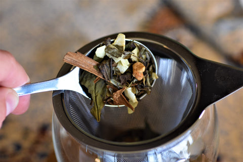 Cup of Cinnamon Chaga Spice tea from Lake Missoula Tea Company, with a steaming, aromatic brew in a clear glass mug.
