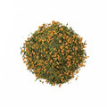 Cup of brewed Genmai Cha tea from Lake Missoula Tea Company, featuring toasted rice and green tea leaves in a clear glass.