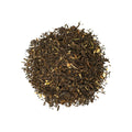 A jar of Jasmine Puerh tea from Lake Missoula Tea Company with loose tea leaves and jasmine blossoms.