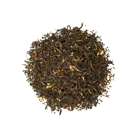 A jar of Jasmine Puerh tea from Lake Missoula Tea Company with loose tea leaves and jasmine blossoms.