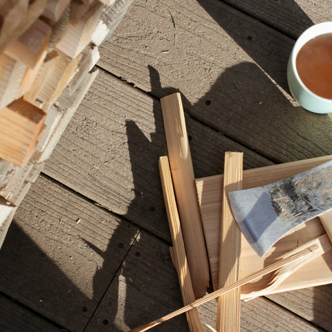 Dried jasmine flowers and Puerh tea in a wooden cup, showcasing Lake Missoula Tea Company's jasmine Puerh tea blend.