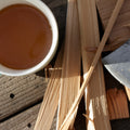 Dried jasmine petals and puerh tea leaves in a wooden cup, showcasing Lake Missoula Tea Company's jasmine puerh tea.