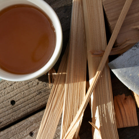 Dried jasmine petals and puerh tea leaves in a wooden cup, showcasing Lake Missoula Tea Company's jasmine puerh tea.