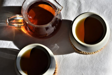 Cup of French Vanilla Almond tea from Lake Missoula Tea Company in a glass carafe, showcasing a warm, inviting tea beverage.
