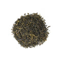 Heritage Green tea leaves from Lake Missoula Tea Company in a clear glass jar with green tea packaging visible.