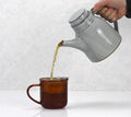 Golden Snail tea from Lake Missoula Tea Company in a traditional teapot, showcasing rich golden-colored tea ready for brewing.