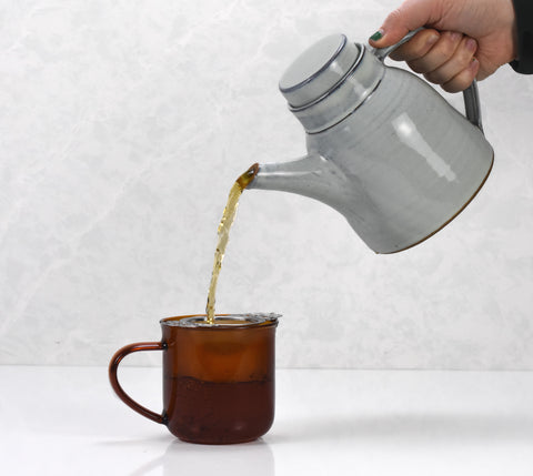 Golden Snail tea from Lake Missoula Tea Company in a traditional teapot, showcasing rich golden-colored tea ready for brewing.