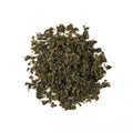 Cup of Jiaogulan immortality herb tea from Lake Missoula Tea Company with fresh dried Jiaogulan leaves in the background.