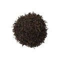 Russian Caravan tea from Lake Missoula Tea Company in a teacup, showcasing rich amber color and traditional packaging.