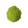 Bright green bowl of Mammoth Matcha tea powder from Lake Missoula Tea Company, with a traditional bamboo whisk and tea cup.