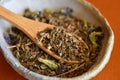 Holy Basil tea from Lake Missoula Tea Company in a glass cup, showcasing fresh, fragrant basil leaves.