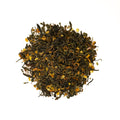 Bottle of Lake Missoula Tea Company's Mimosa Oolong tea in a clear glass with a golden amber color.