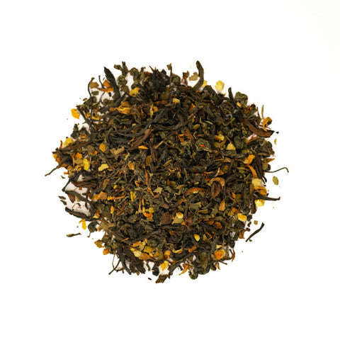 Bottle of Lake Missoula Tea Company's Mimosa Oolong tea in a clear glass with a golden amber color.