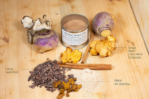 A steaming cup of Mushies’ Instant Cup™ tea from Lake Missoula Tea Company with tea bag and fresh ingredients visible.