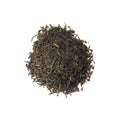Cup of Mountain Spring Green tea from Lake Missoula Tea Company, showcasing fresh green tea leaves and brewed tea in a clear glass.
