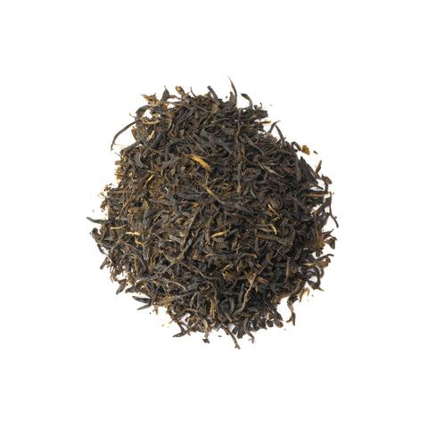 Cup of Mountain Spring Green tea from Lake Missoula Tea Company, showcasing fresh green tea leaves and brewed tea in a clear glass.