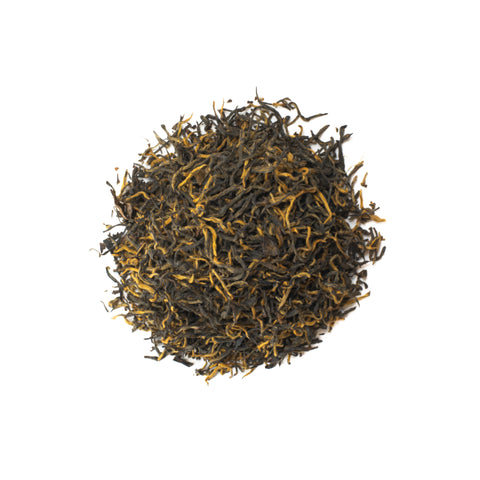 Golden Monkey tea from Lake Missoula Tea Company in a clear glass teapot with steeped golden-brown leaves and brewed tea.