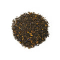 Loose Empress Grey tea leaves from Lake Missoula Tea Company in a clear glass jar, showcasing the aromatic grey tea blend.