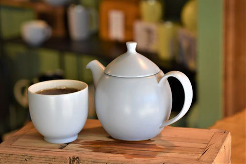 Black tea from Lake Missoula Tea Company's Big Sky Breeze collection, shown in a clear glass teapot with brewed tea inside.