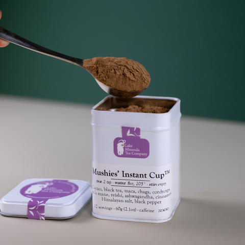 Mushies’ Instant Cup™ tea by Lake Missoula Tea Company in a clear plastic cup with tea bags and branding visible.