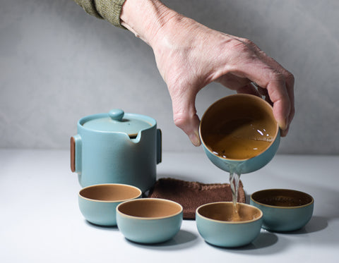 Light blue minimalist image of Golden Eyebrows Jin Jun Mei tea leaves from Lake Missoula Tea Company.