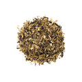 Bodacious Blue Tea from Lake Missoula Tea Company, brewed in a cup with vibrant blue leaves and fresh tea leaves visible.