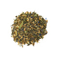 Jurassic Ginger Green Tea by Lake Missoula Tea Company, fresh green tea leaves with slices of ginger, in a clear tea cup.