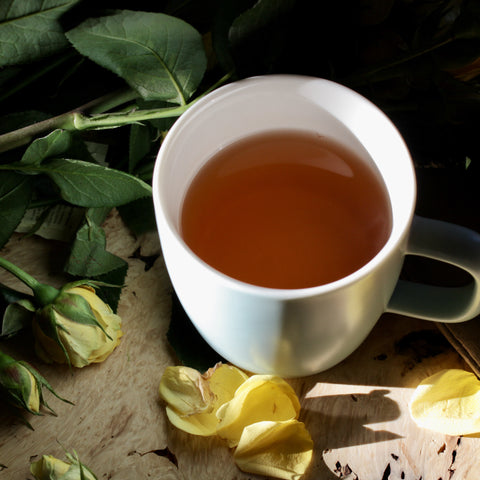 Red elephant-shaped tea by Lake Missoula Tea Company with dried flowers in a wooden cup.