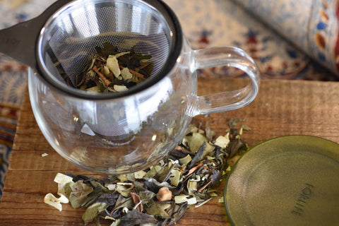 Loose leaf Cinnamon Chaga tea from Lake Missoula Tea Company, brewing in a glass teapot with a cloudy infusion.