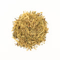 A cup of Licorice Mint tea from Lake Missoula Tea Company, featuring a tea bag and fresh mint leaves in a cozy setting.