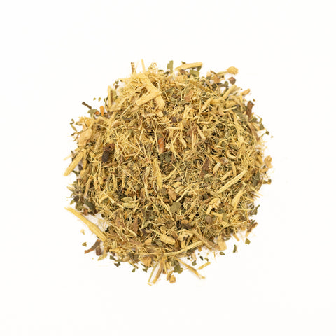 A cup of Licorice Mint tea from Lake Missoula Tea Company, featuring a tea bag and fresh mint leaves in a cozy setting.