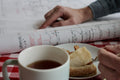 A steaming cup of Rose Chai tea from Lake Missoula Tea Company, held in hands with a cozy, inviting setting.
