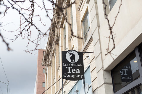 Lake Missoula Tea Company's Evening in Missoula tea sign displayed on a store storefront.