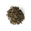 Fresh jasmine green tea leaves from Lake Missoula Tea Company in a clear glass jar, showcasing the fragrant, loose tea.