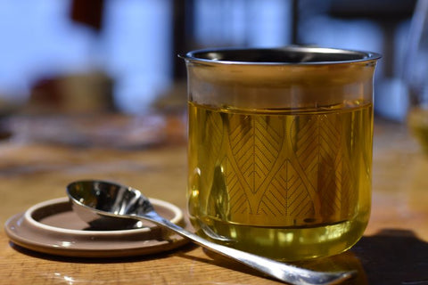 Close-up of Lake Missoula Tea Company's Maureen's Cure singer's tea in a clear tea cup, showcasing its herbal blend and vibrant color.