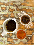 Brewed Eastern Beauty tea from Lake Missoula Tea Company in a clear glass cup, showcasing golden-colored tea.