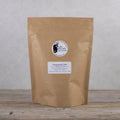 A 500g package of Lake Missoula Tea Company's Chamomile Calm herbal tea with dried chamomile flowers.