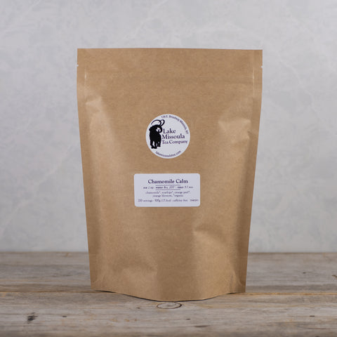 A 500g package of Lake Missoula Tea Company's Chamomile Calm herbal tea with dried chamomile flowers.