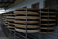 Drying racks with fresh jasmine green tea leaves from Lake Missoula Tea Company, showcasing tea drying process.