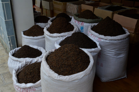 Loose Keemun tea leaves from Lake Missoula Tea Company in a clear glass jar showing dark, aromatic tea leaves.