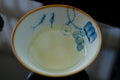 Green Puerh wedding cake tea from Lake Missoula Tea Company, showing a dense, pressed tea cake with rich green color.